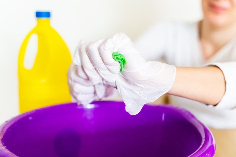 Woman Cleaning with Chlorine Bleach, Sodium Hypochlorite Solution